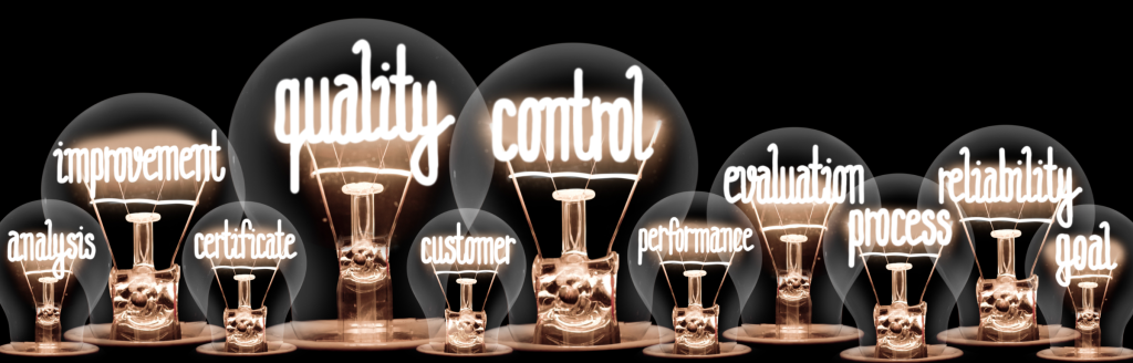 Light bulbs with terms inside such as quality and control to indicate an idea.